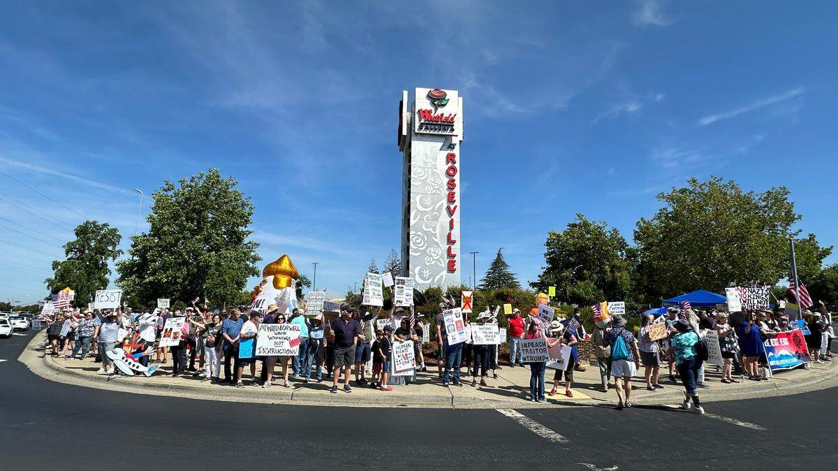 Approximately 5,000 people lined a four-way intersection near the Roseville Galleria on Saturday with signs protesting President Donald Trump.
