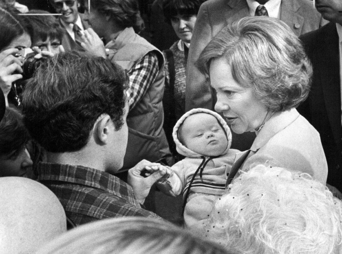 Mark Meaker, a spectator to Rosalynn Carter’s visit to the Sacramento Childrens Home on Oct. 14, 1980, talks with the first lady as she holds Meakers’ 4-month-old son Matt, who has Down’s syndrome. Meaker said he wanted to see the Carter because of her interest in hleping children like his son. “I’m a Republican, but I like Mrs. Carter’s stand on mental illness. Her support of a program provides federal federal funds that help my son,” he said.