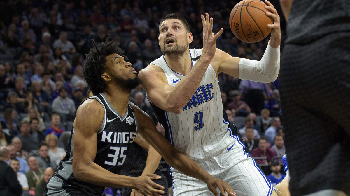 Orlando Magic center Nikola Vucevic drives to the basket past Sacramento Kings forward Marvin Bagley III on Monday night.