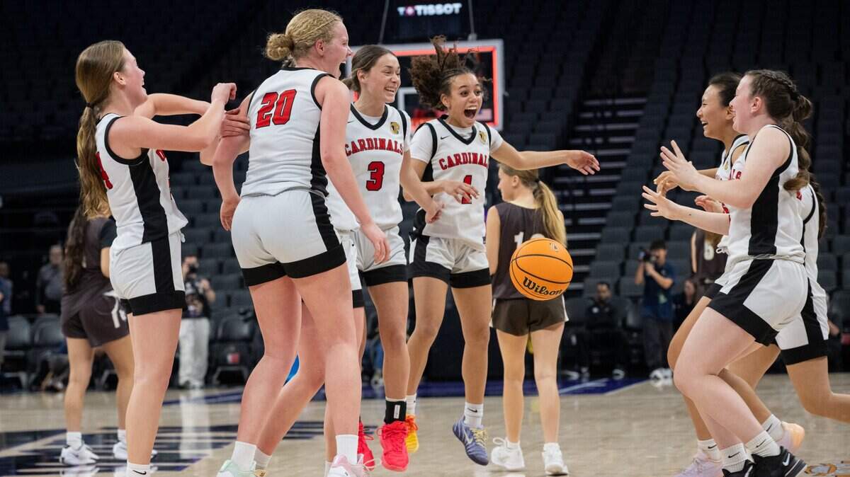 Woodland Christian’s Annabell Baker (1), Ellie Sumner (3), Siena Sorbello (20) and other teammates celebrate beating Laguna Hills during the CIF State Division V girls basketball championship at the Golden 1 Center on Friday.