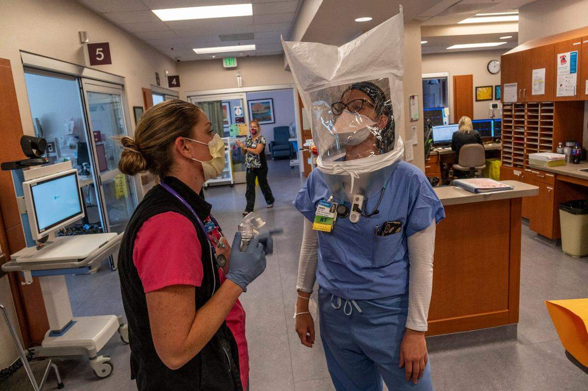 Amber Marshall, right, a respiratory therapist, has her N95 mask tested by Natasha Benedet, RN, left, inside the ICU for COVID patients at Marshall Medical Center’s hospital in Placerville on Wednesday, Dec. 2, 2020.