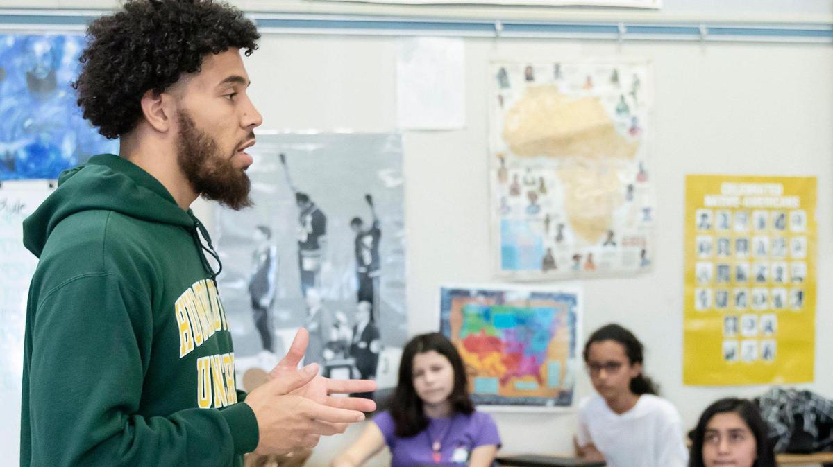 Rio Tierra journalism and history teacher Jordan McGowan, left, goes over the agenda for the day during his journalism class on Wednesday, March 11, 2020, in Sacramento.