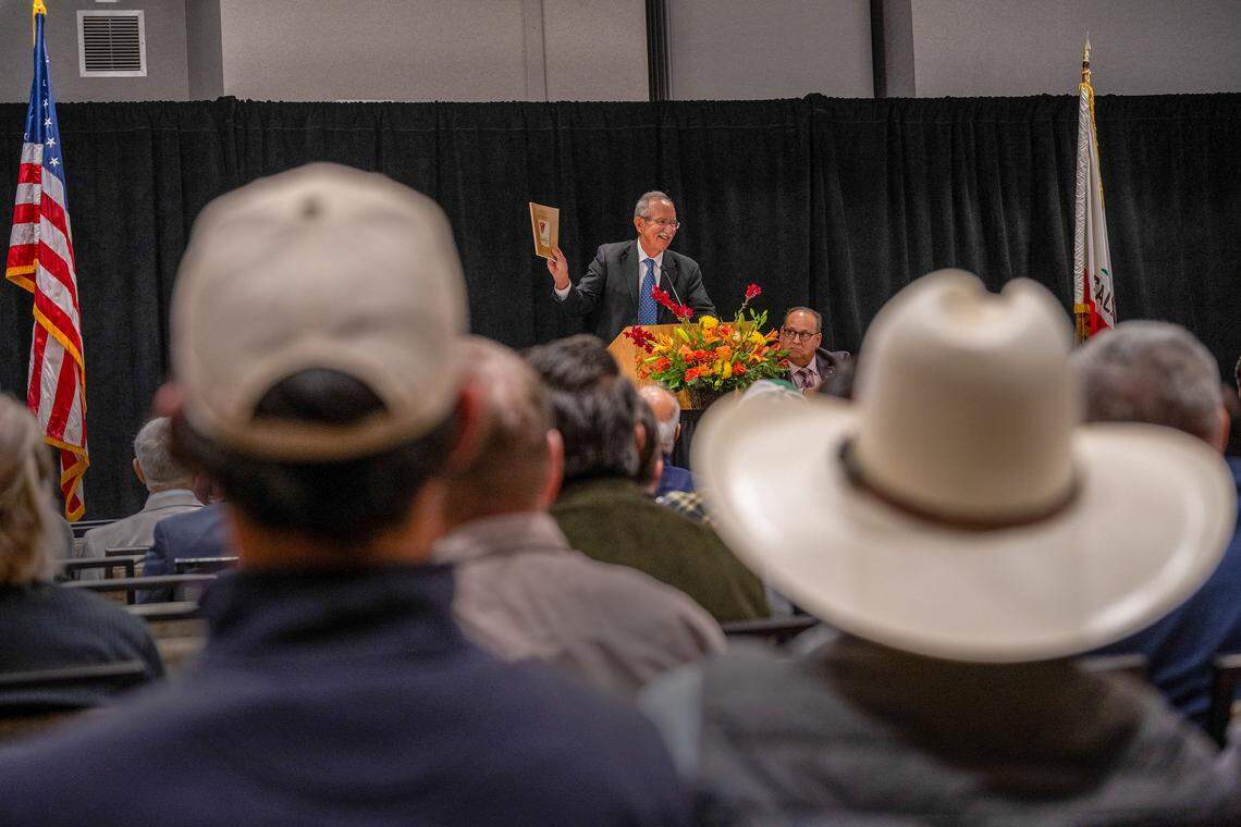 Rich Hudgins holds up the 100th anniversary catalog at the California Canning Peach Association’s annual meeting in Sacramento on Feb. 4 to remind peach farmers the organization is there to help after Del Monte’s closure. In 1980, 11 canners operated — now there is just one: Pacific Coast Producers.