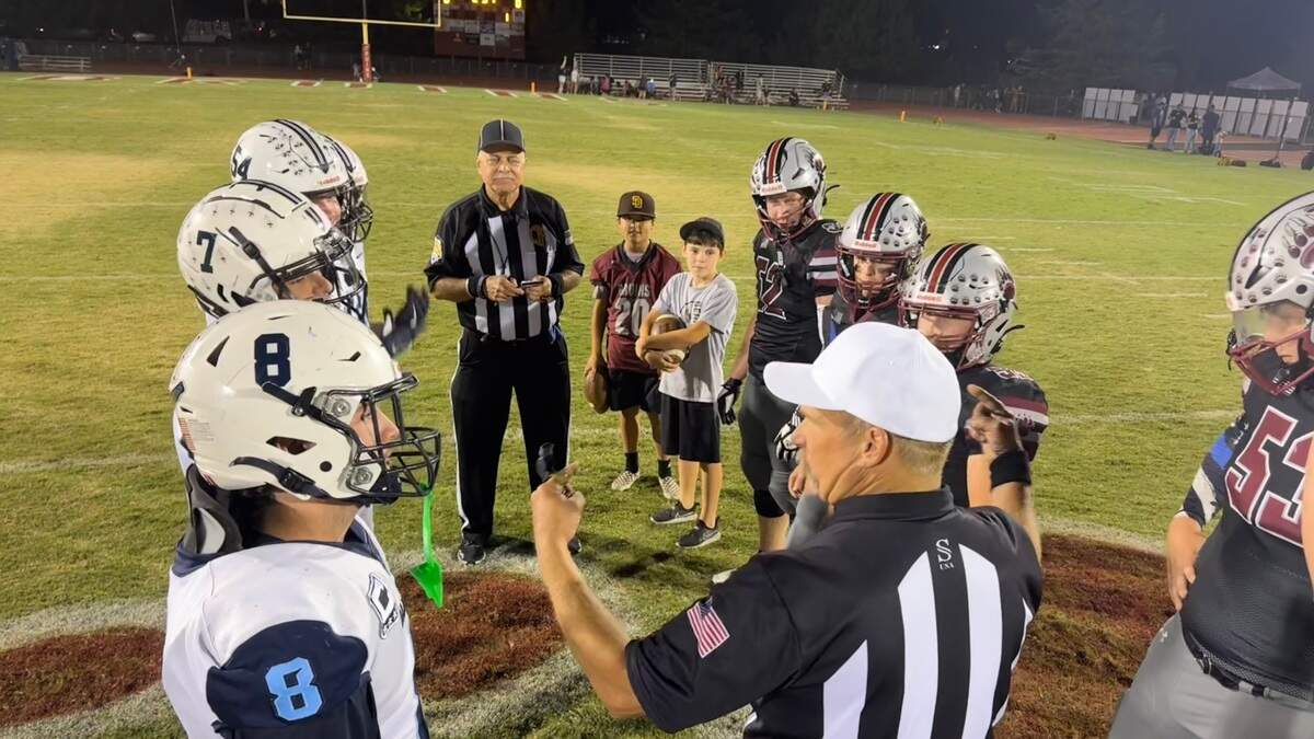 Team captains for Oakmont, left, and Bear River meet before the game for the coin toss Friday. Bear River won, 24-21.