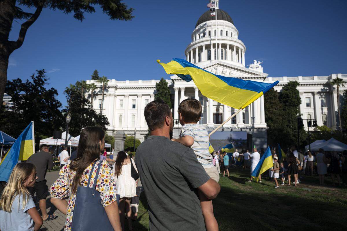 Ukrainian Americans wave Ukrainian flags during a Ukrainian Independence Day celebration at the California Capitol in Sacramento on Sunday.