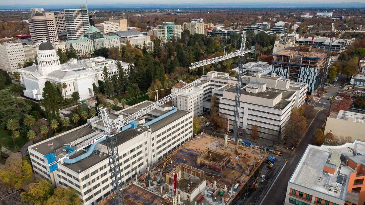 The state building under construction at 10th and O streets in downtown Sacramento, center, seen Thursday, Dec. 5, 2019, will temporarily house legislators and the governor as the existing annex attached to the Capitol building is improved.