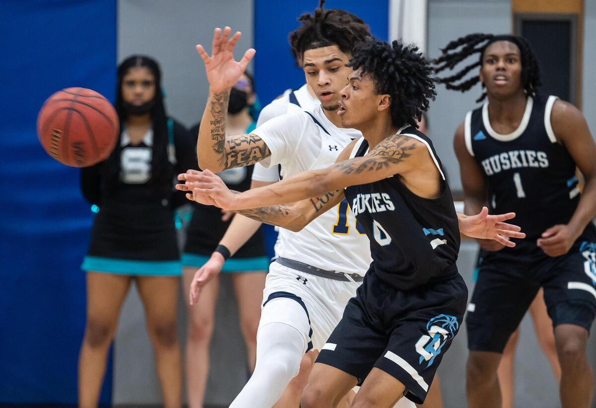 Sheldon Huskies’ Tyrice Daniels (0), right, passed past Inderkum Tigers’ Derrick Claxton (10) during the third period at the high school boys basketball Sac-Joaquin Section Division I semifinal playoff game Wednesday, Feb. 23, 2022, at Inderkum High School in Sacramento. Sheldon beat Inderkum, 85-80, to advance to the title game.