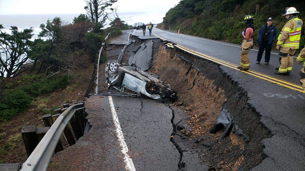 Someone removed a barricade and road closure sign before crashing into a hole left by a landslide, Oregon sheriff’s officials say.