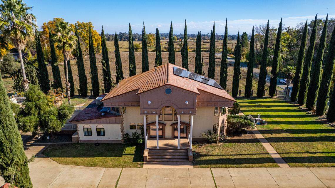The estate is lined by cypress trees.