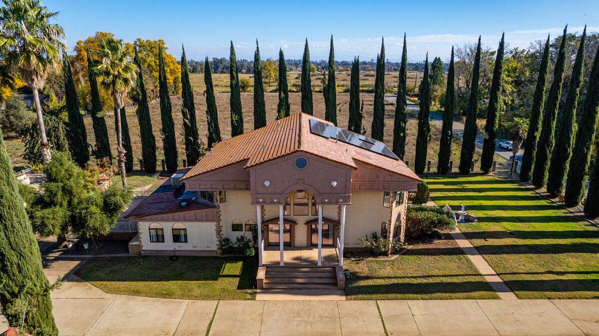 The estate is lined by cypress trees.