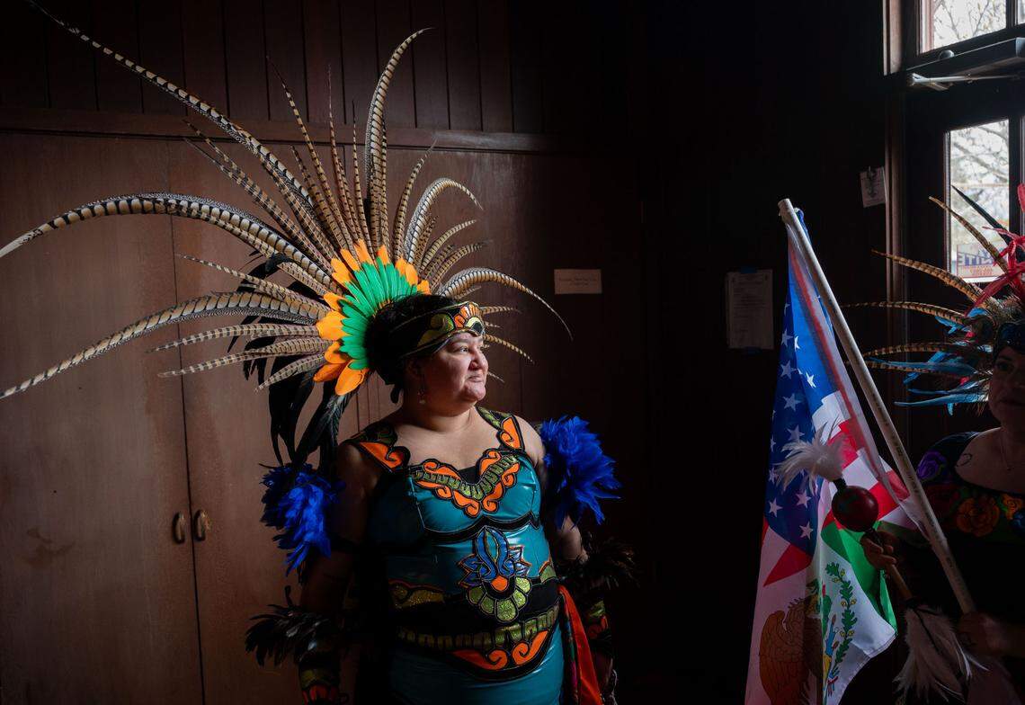 Liliana Hernandez, a dancer with the Danza Azteca Huitzitzilin Ollin, waits to perform in the Stockton church that Iglesia Luterana Santa María Peregrina is using for services.