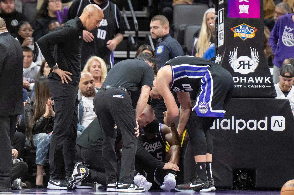 Sacramento Kings guard De’Aaron Fox (5) stays on the ground after being fouled by Los Angeles Lakers guard Gabe Vincent (7) in the second half on Sunday.