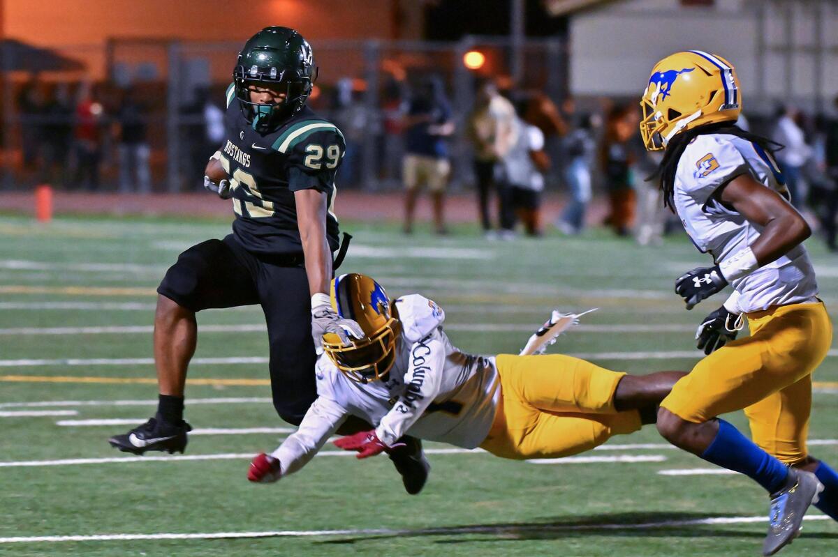 The Monterey Trail Mustangs Vontrelle Waffer (29) gains four yards before being tackled by the Grant Pacers Wayshawn Parker (1) in the second half of the game on Friday, Oct. 20, 2023, at Monterey Trail High School in Elk Grove.
