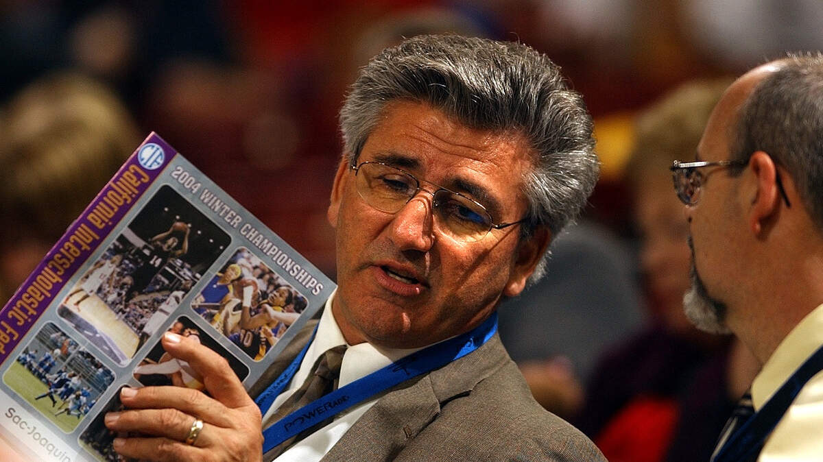 CIF Sac-Joaquin Section Commissioner Peter Saco holds a program for the winter basketball playoffs on Friday, Feb. 5, 2004, at Arco Arena.