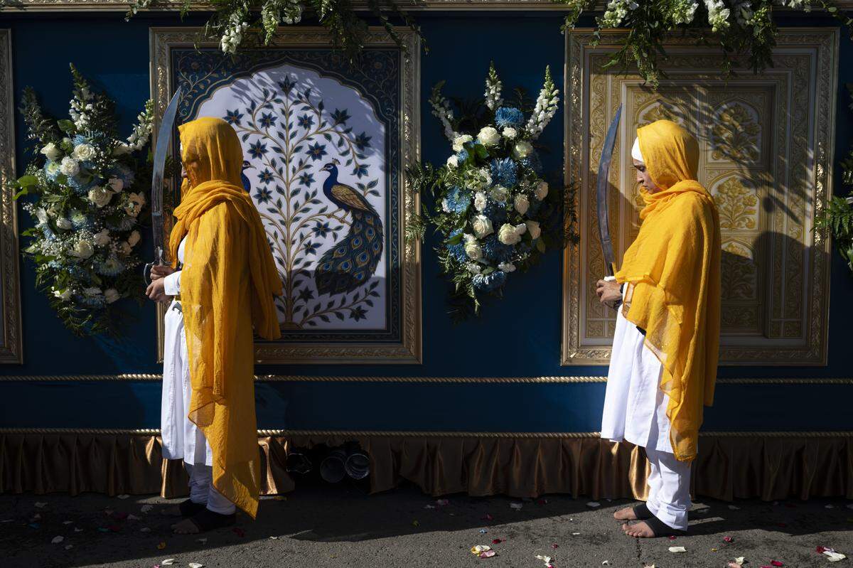 Members of the panj piayra protect the main float during Nagar Kirtan, also known as the Sikh Parade, in Sutter County on Sunday.