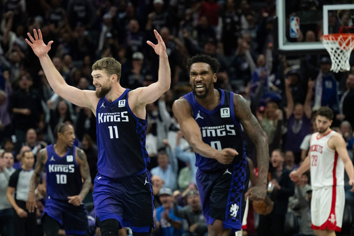 Sacramento Kings center Domantas Sabonis (11) and guard Malik Monk (0) react after a De’Aaron Fox (5) basket during an Emirates NBA Cup game at Golden 1 Center on Tuesday.