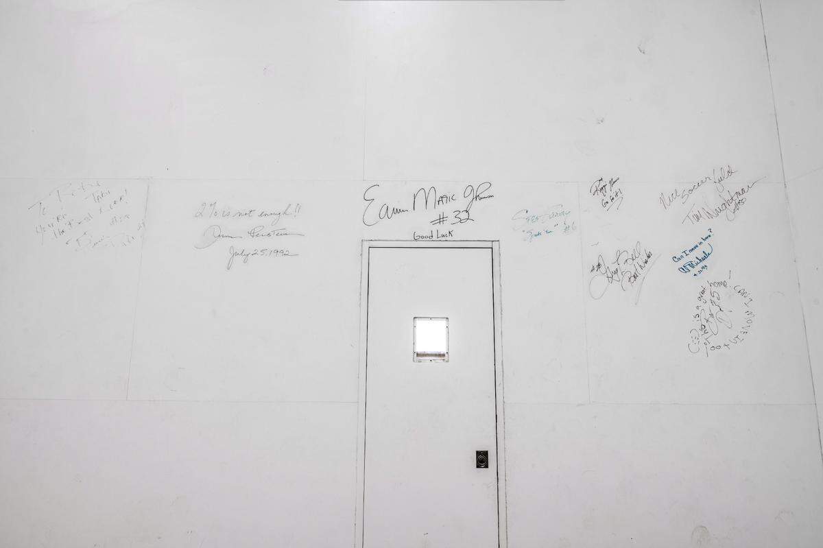 Famous NBA players’ signatures adorn a locker room wall inside the house.