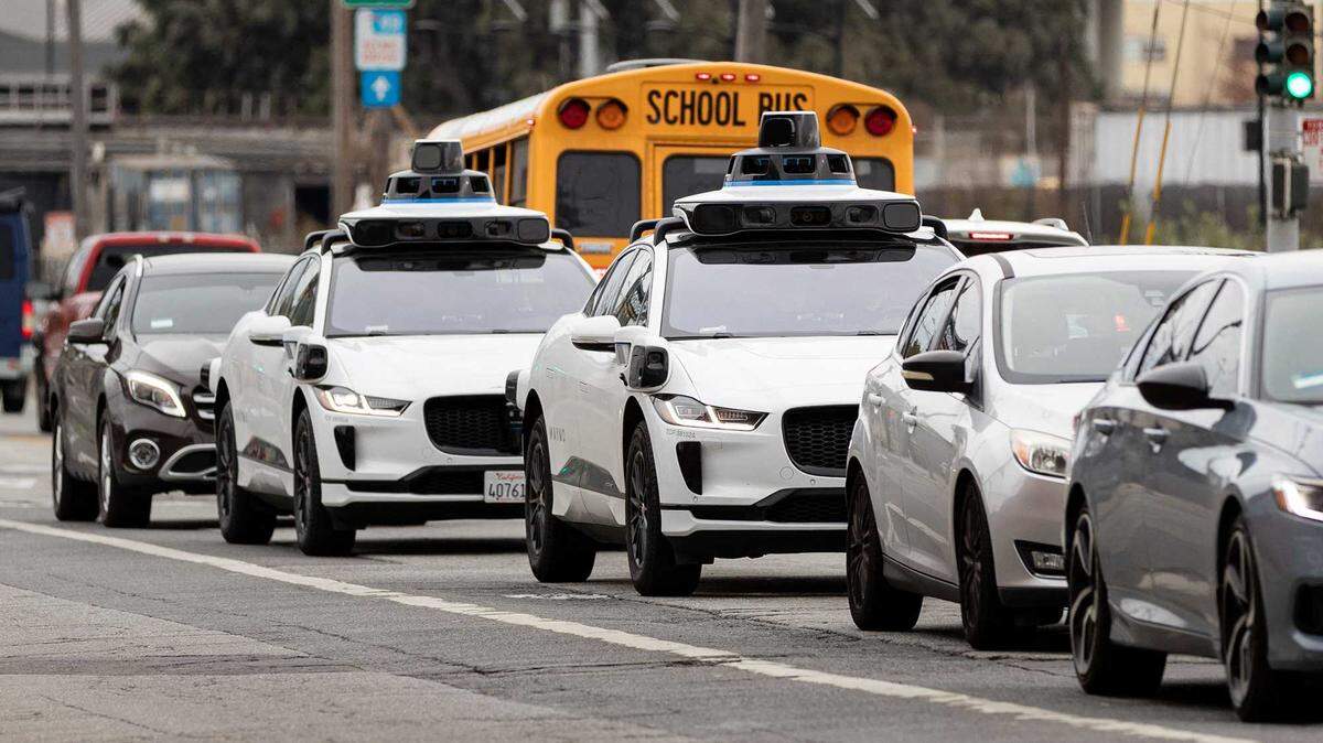 Waymo autonomous vehicles operate on Cesar Chavez Street in San Francisco in 2023.