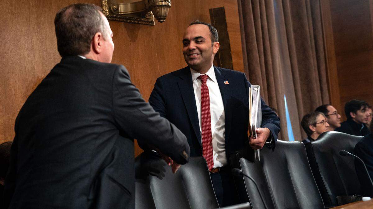 Former Consumer Financial Protection Bureau director Rohit Chopra is greeted by Sen. Adam Schiff, D-Calif., before he testifies at a Senate Banking, Housing, and Urban Affairs Committee hearing on Capitol Hill on Dec. 11, 2024 in Washington, DC. 