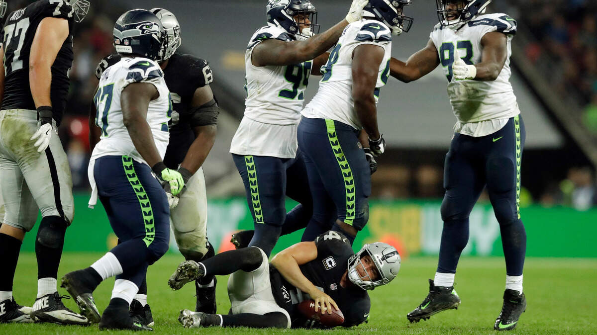Raiders quarterback Derek Carr was sacked four times in a loss to the Seattle Seahawks on Oct. 14 in London. It was a rough game for rookie tackles Kolton Miller (77) and Brandon Parker.