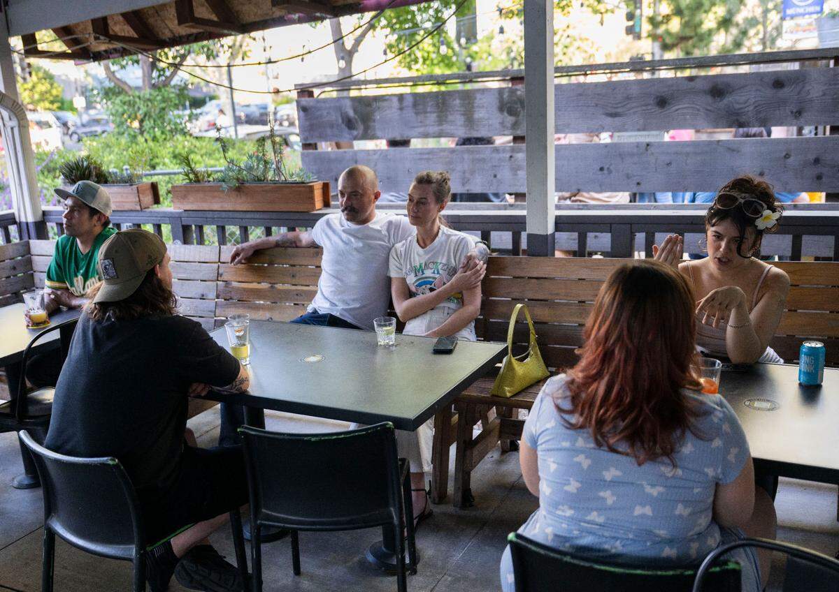 Customers enjoy the outdoor deck in front of the Golden Bear in midtown on Saturday, April 12, 2025. Under a proposal that the Sacramento City Council will consider, they could soon be able take their drinks out to the street during certain designated events.