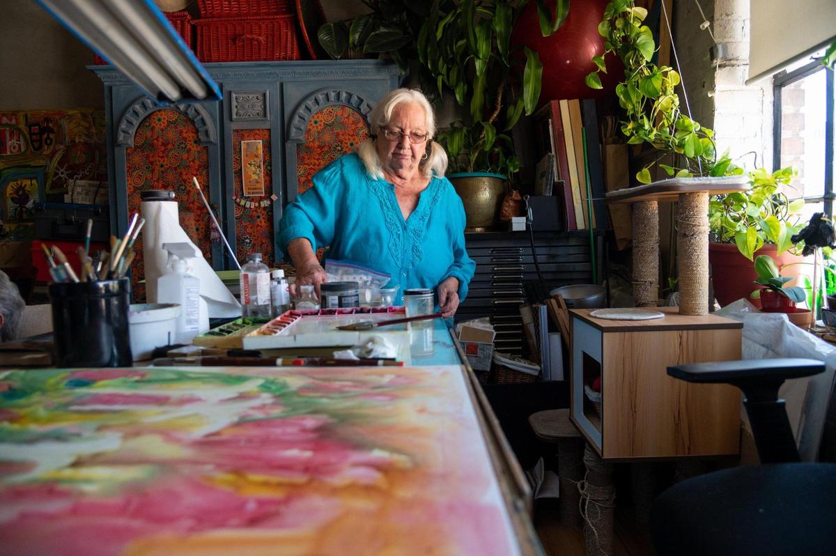 Chloe Fonda, 87, walks around the workspace where she paints in the Warehouse Artist Lofts in Sacramento earlier this month. She has been creating art since she was a child.