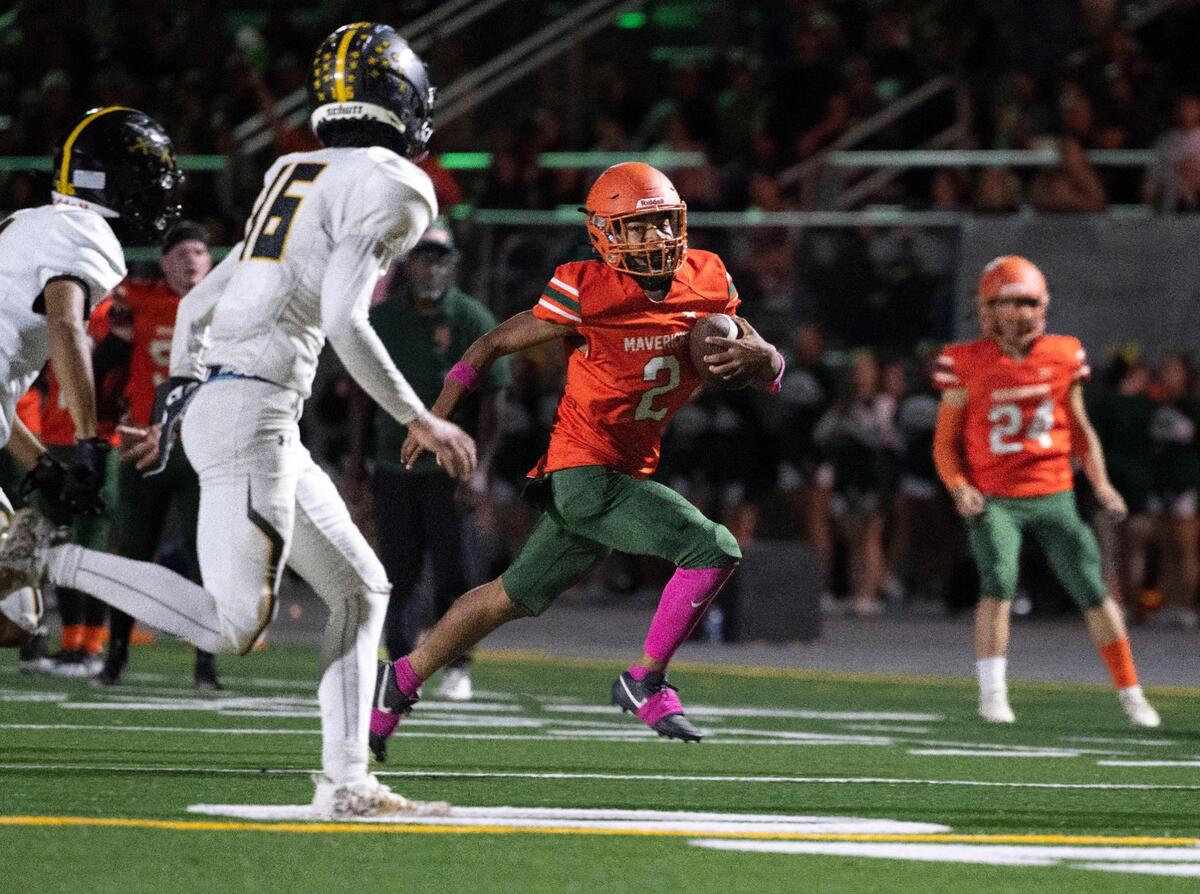 Mesa Verde’s Jeremiah Dauphine runs with the ball before being forced out of bounds during a game against Rio Linda High School on Friday, Oct. 13, 2023, on the team’s brand-new football field, a project 40 years in the making.