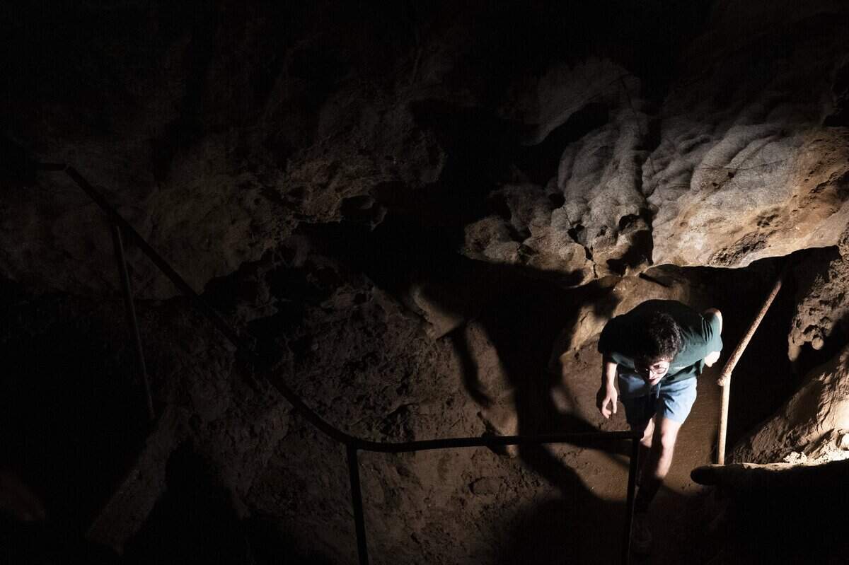 Maxx Muldoon enters a section of California Cavern in Mountain Ranch on Thursday, June 18.