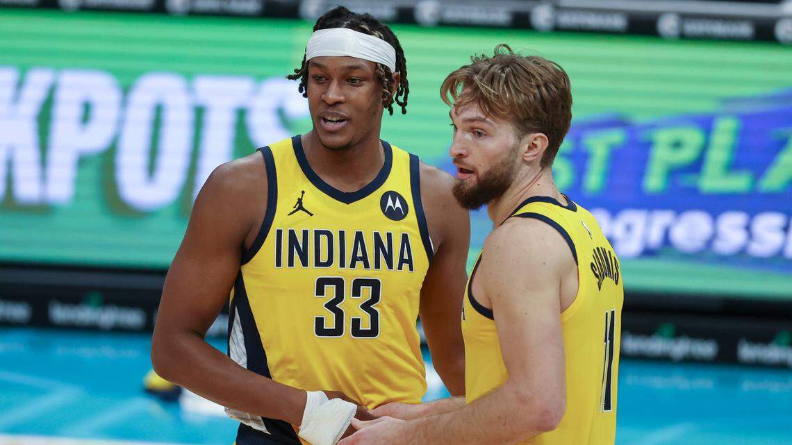 Indiana Pacers forward Domantas Sabonis, right, and Indiana Pacers center Myles Turner talk during a break in the action against the Charlotte Hornets in the second half of an NBA basketball game in Charlotte, N.C., Wednesday, Jan. 27, 2021. Indiana won 116-106. (AP Photo/Nell Redmond)