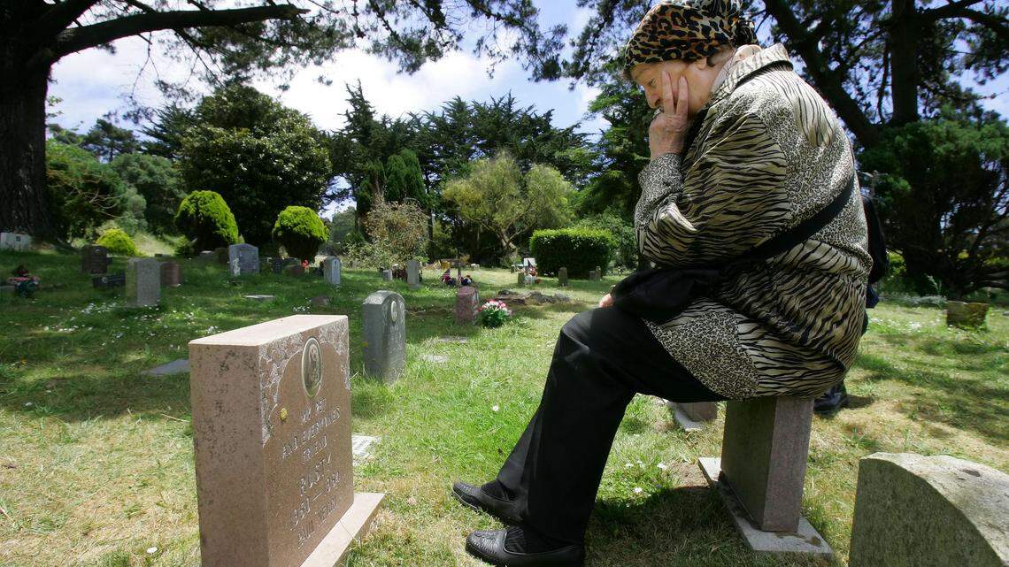 Nila Negri sits in front of her dog Rusty's grave site at Pet's Rest cemetery in Colma, Calif., Wednesday, June 14, 2006.  The city, also home to 1.5 million deceased humans, is running out of room for new graves.