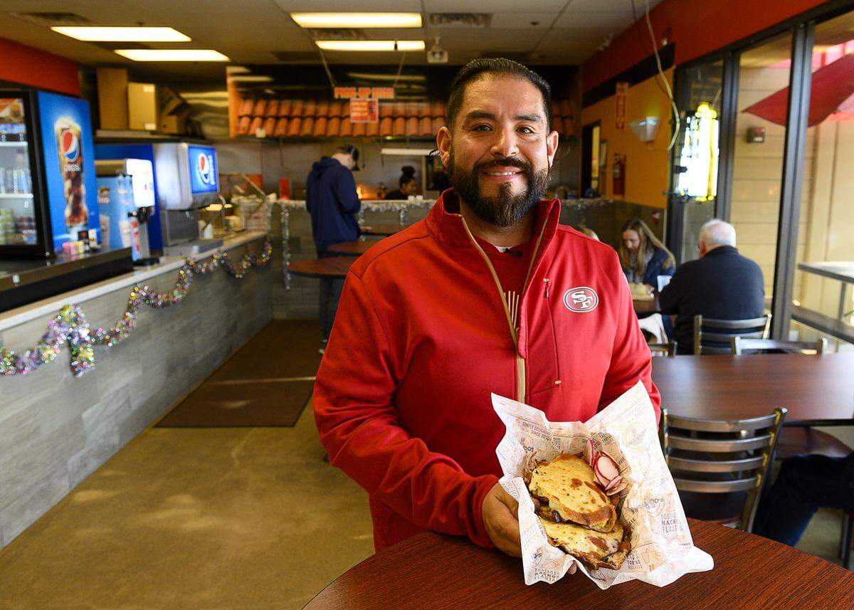 Lisandro “Chando” Madrigal holds adobada mulitas at Chandos in 2019 in West Sacramento. Chando’s Tacos abruptly closed its three remaining locations Tuesday.