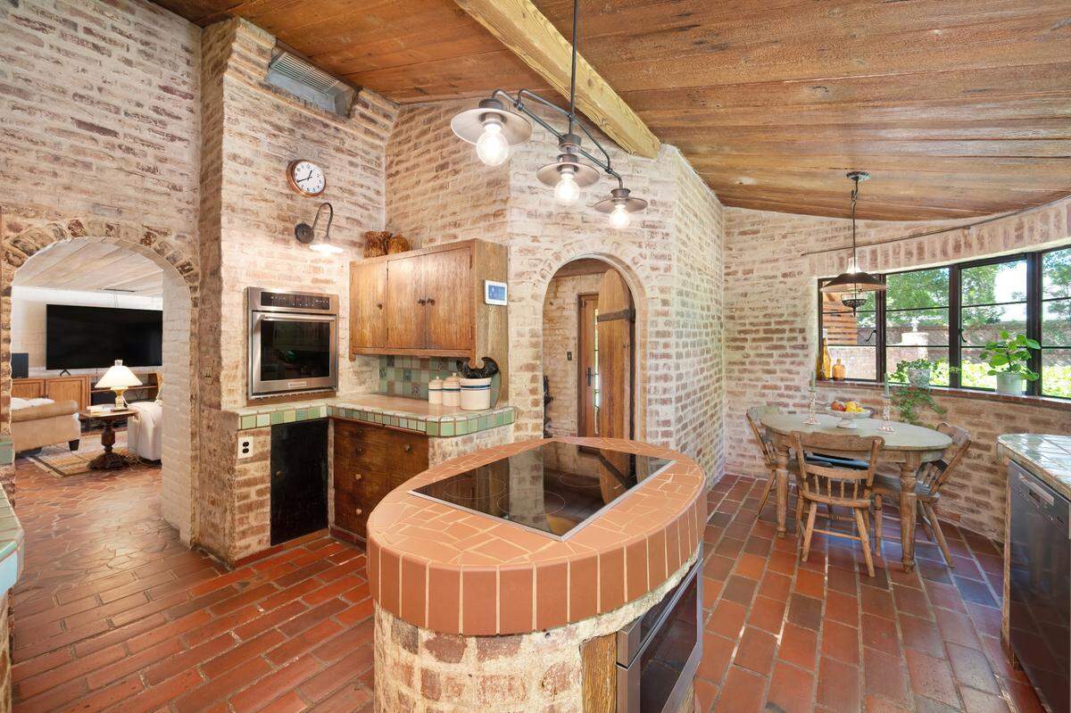 Burners built into the island have always been part of the delightful kitchen with breakfast nook.