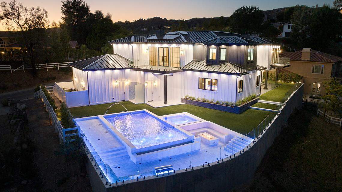 Modern farmhouse hidden in scenic hills lists in California. See the chic home