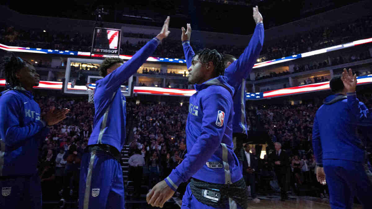 Sacramento Kings guard Davion Mitchell (15) high fives teammates during an NBA game between the Sacramento Kings and the Golden State Warriors on Friday, April, 7, 2023 at Golden 1 Center.