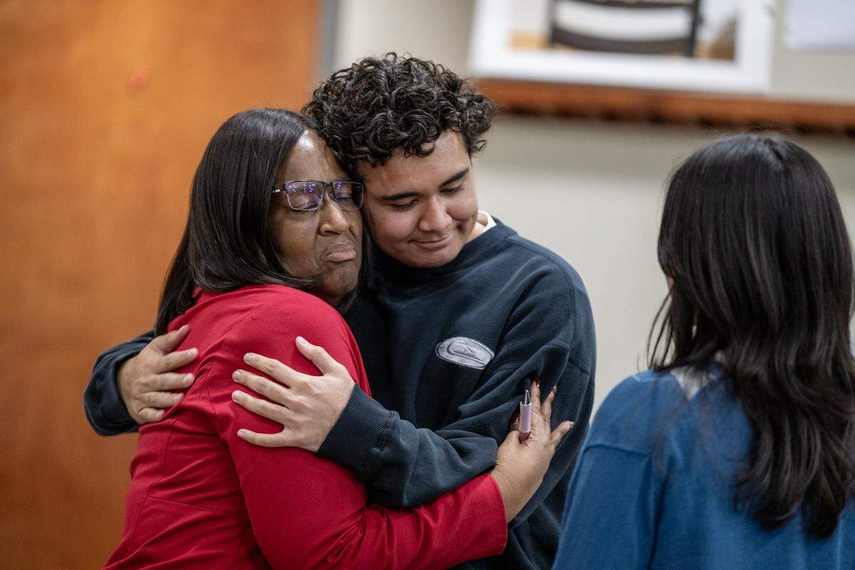 Owen Naqica, a student at West Campus, embraces Lisa Allen before she resigned as superintendent of the Sacramento City Unified School District during a meeting on Thursday at the Serna Center in Sacramento.