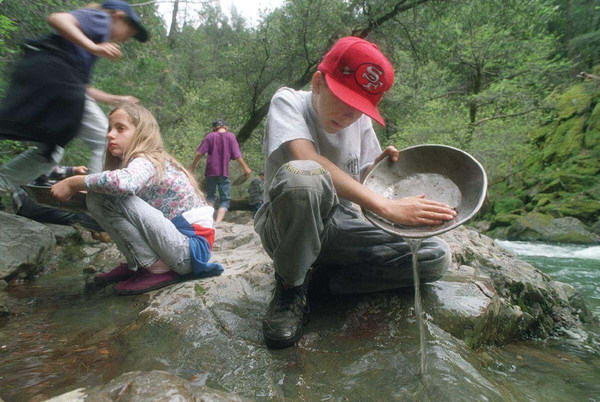 In this Bee photo from 1995, Natasha Tsvyk, 11, left and Joe Adams, 11, relive history by panning for gold in Park Creek. During a week’s stay at Sly Park, sixth graders learn about the history of the local environment, survival skills and about conservation.