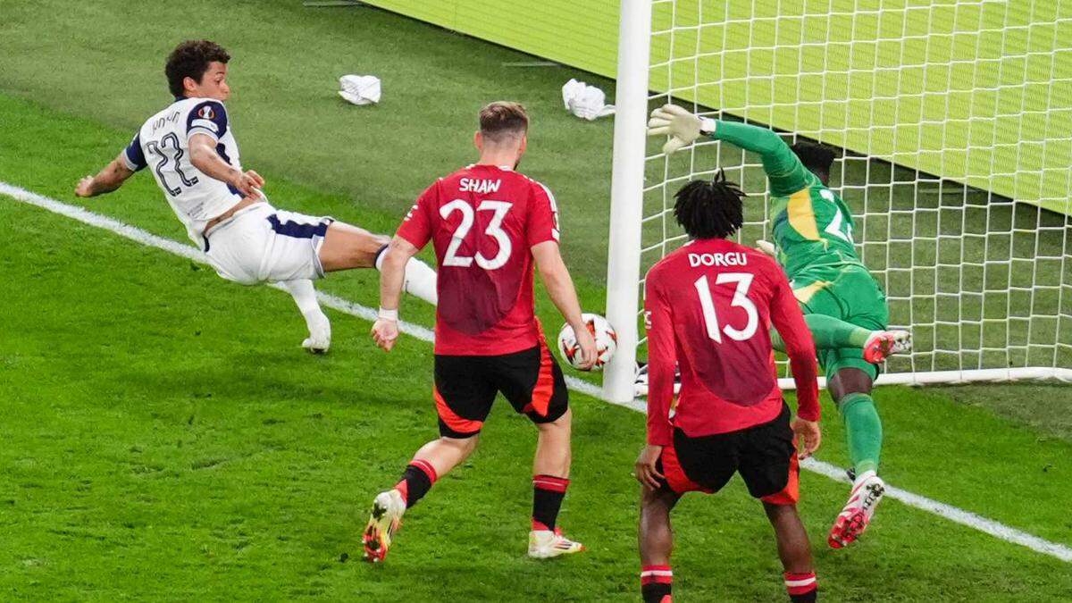 Manchester United’s Luke Shaw scores an own goal following a cross from Tottenham Hotspur’s Brennan Johnson during the UEFA Europa League final Wednesday at Estadio de San Mames in Bilbao, Spain.