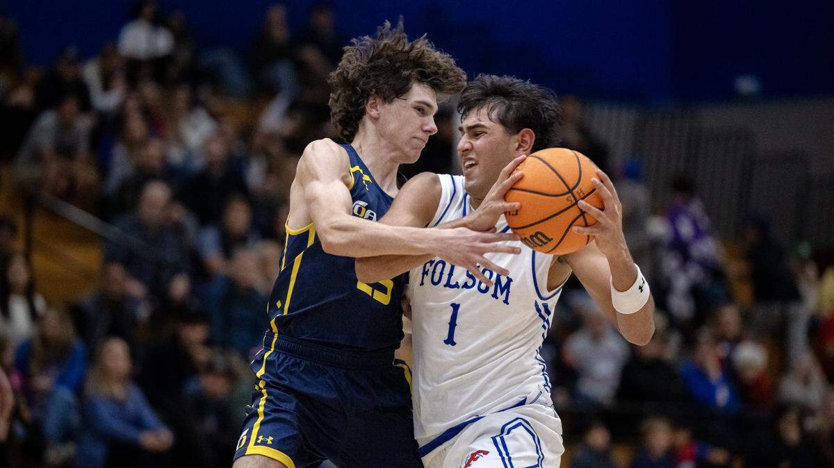 The Oak Ridge Trojans' Will Howard defends Joven Dulay of the Folsom Bulldogs during the first half Jan. 23 in Folsom. Dulay on Friday had the game-winning assist to Parks Weaver at the buzzer to beat McClatchy 65-63 in a CIF Sac-Joaquin Section Division I quarterfinal.