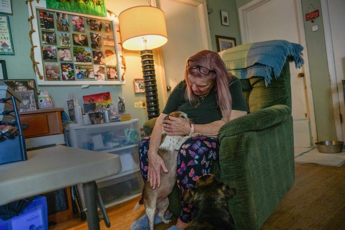 Cheryl Pringle wears a beaded bracelet on May 19, 2025, with her son’s name on it as she holds “Momma.” Her son, Andrew Pringle, had rescued the dog. Pringle said she finds comfort in the pets he left behind.