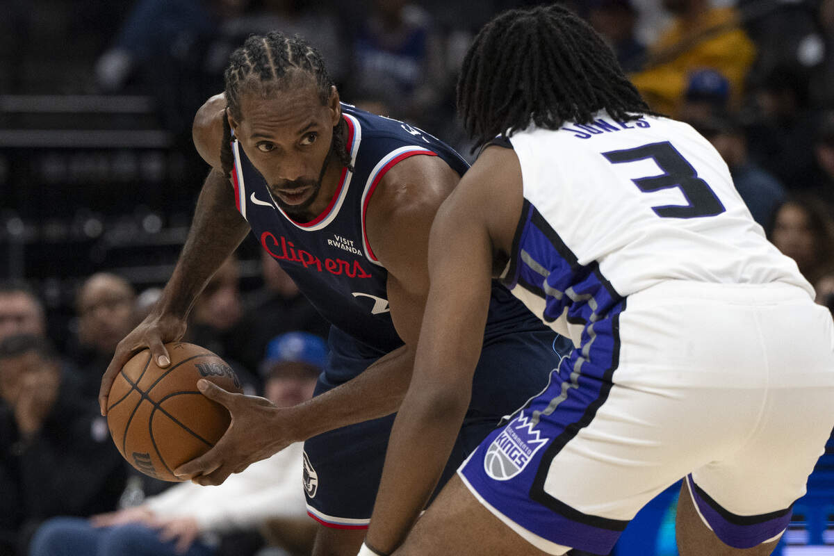 LA Clippers forward Kawhi Leonard (2) is guarded by Sacramento Kings forward Isaac Jones (3) during a game between the Kings and the Clippers at Golden 1 Center in Sacramento on Wednesday, Oct. 15, 2025.