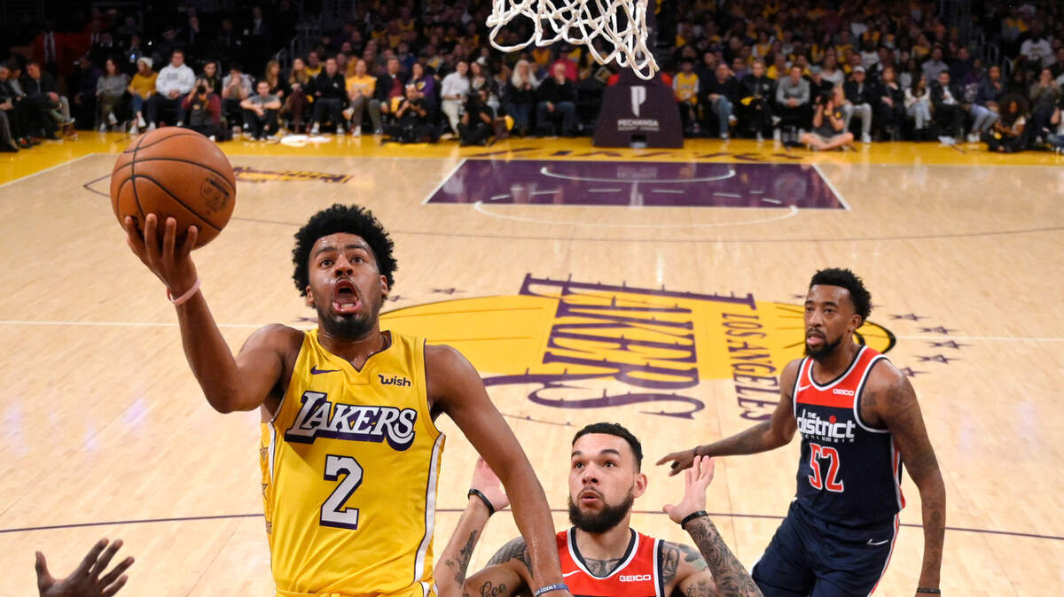 Los Angeles Lakers guard Quinn Cook, left, shoots as Washington Wizards guard Chris Chiozza, center, defends and guard Jordan McRae watches during the second half of an NBA basketball game Friday, Nov. 29, 2019, in Los Angeles. The Lakers won 125-103. (AP Photo/Mark J. Terrill)