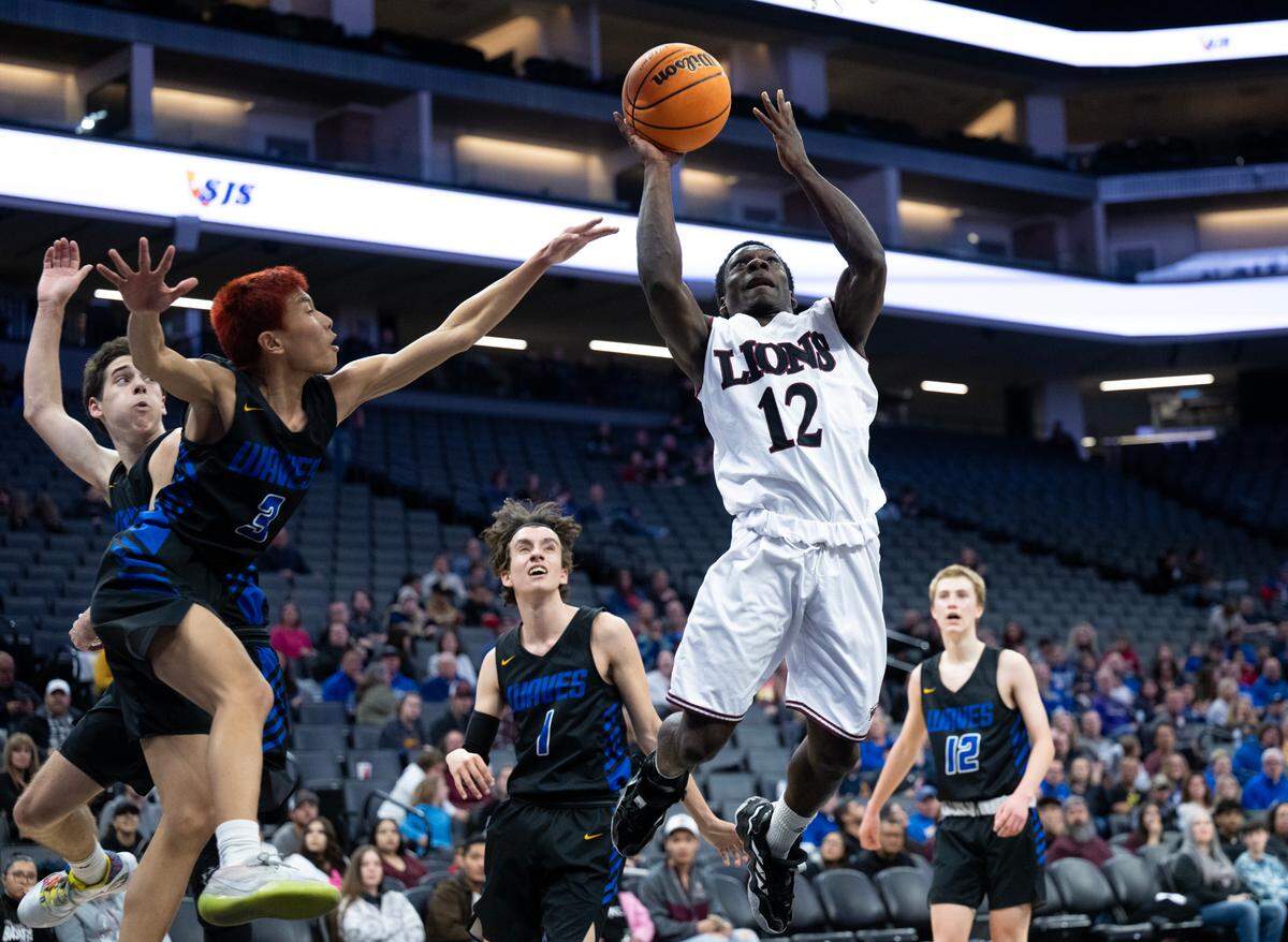 The Valley Christian Lions’ Rod Williams drives for a basket against the Sacramento Waldorf Waves’ Zihao Chen during the CIF Sac-Joaquin Section Division VI high school boys basketball championship game Friday.