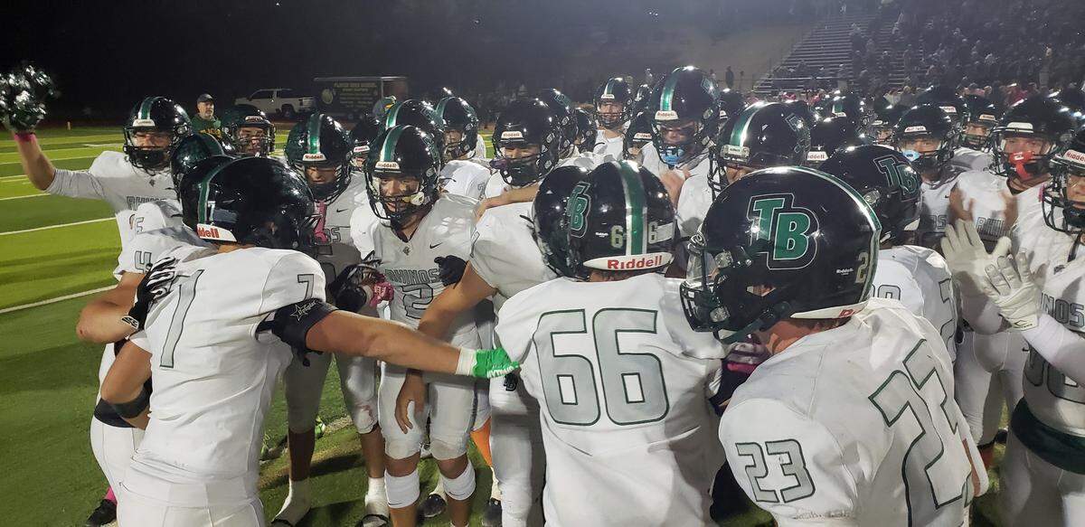 Lincoln’s Twelve Bridges Raging Rhinos players pump up each other before racing to a 51-34 win over Placer High School in Auburn Friday, Oct. 18, 2024, and remain unbeaten at 8-0.