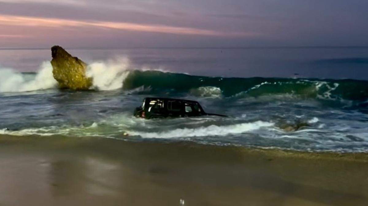 California officials rescued one person after a Jeep was pulled into an ocean by waves.