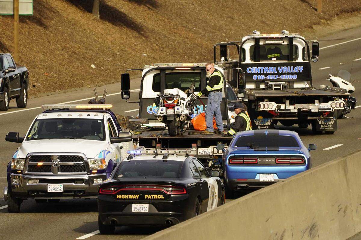 The motorcycle driven by an police officer who was killed after being struck by a man driving the wrong way on southbound Highway 99 is tied down on a tow truck in Friday in Sacramento. The officer, a six-year veteran of the Elk Grove Police Department, was riding on Highway 99 when he was hit around 5:15 a.m. He was taken to a hospital where he died.