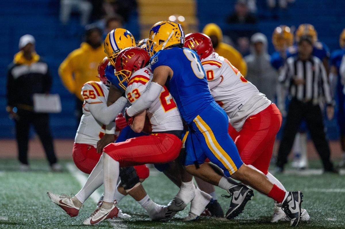 The Jesuit Marauders’ Jack Patock (23) is stopped at the line of scrimmage by the Grant Pacers’ Jeremiah Tuiileila (8) in the first half a Sac-Joaquin Section Division II quarterfinal playoff game on Friday, Nov. 15, 2024 in Del Paso Heights.