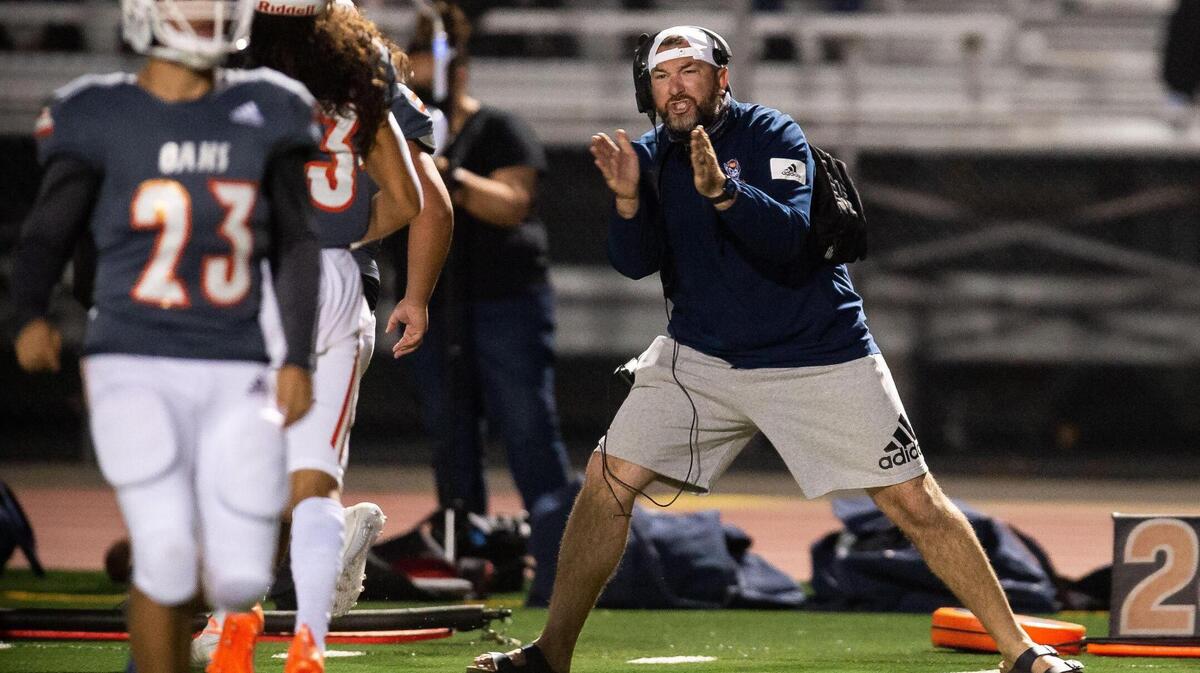 Cosumnes Oaks head coach Andrew Bettencourt celebrates a first quarter touchdown run against Monterey Trail during the high school football game Friday, April 2, 2021, at Monterey Trail High School in Elk Grove. Monterey Trail beat Cosumnes Oaks 57-21.