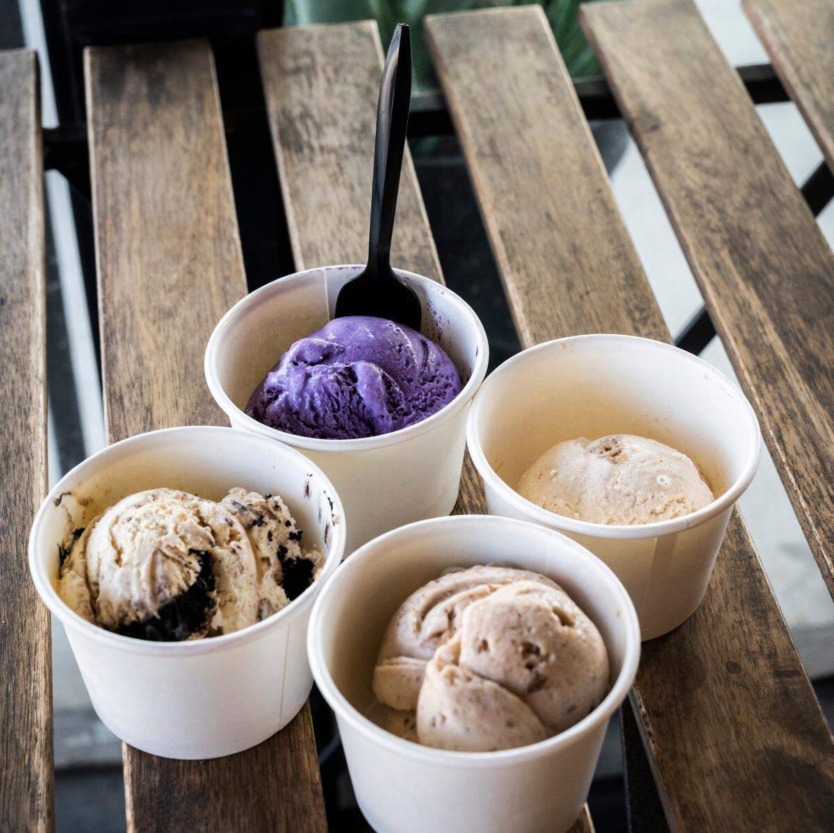 Cornflower Creamery ice cream flavors s’mores, left, ube (a purple sweet potato), top, cinnamon snickerdoodle, right and vegan pecan praline, bottom, are served in cups at Buffalo Pizza & Ice Cream Co. in Sacramento on Sunday, Nov. 1, 2020.