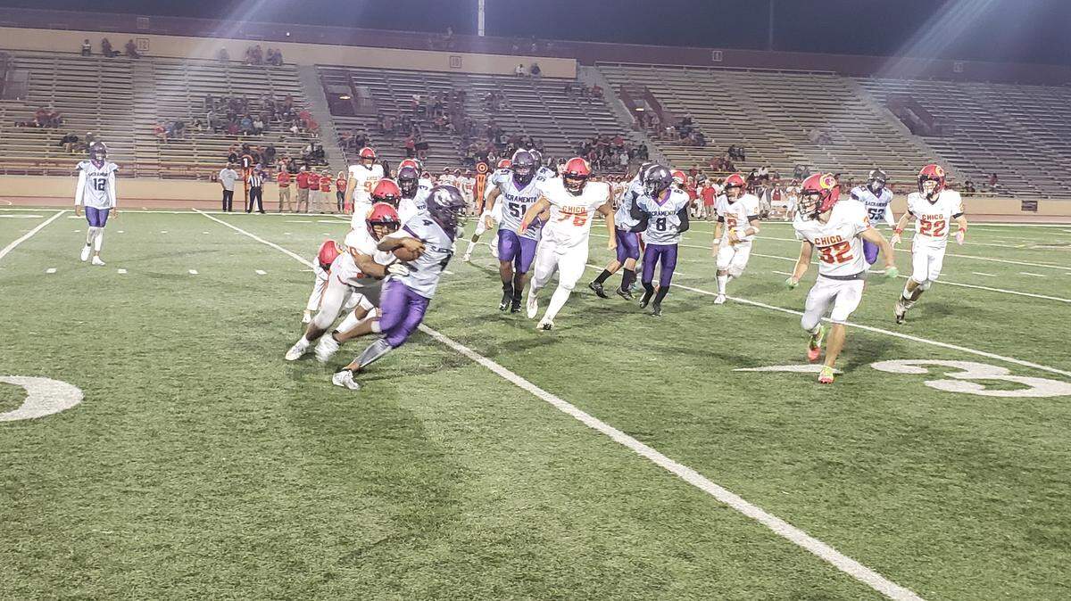Sacramento’s Deyvon Drayton is swarmed in the backfield by Chico defenders during the Panthers’ 26-18 win Friday at Hughes Stadium.