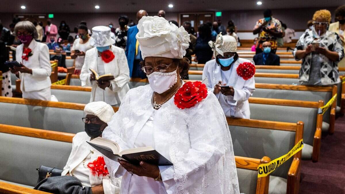 Mother Rosemary Marshall, 78, middle, of Sacramento, reads the Bible with fellow congregants during a service at St. Paul Missionary Baptist Church in Oak Park in Sacramento on Easter Sunday on April 4, 2021. It was the churchs first indoor service since March 2020 because of the coronavirus pandemic.